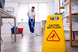 Male janitor offering commercial office cleaning services