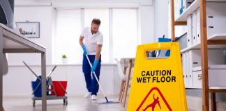 Male janitor offering commercial office cleaning services
