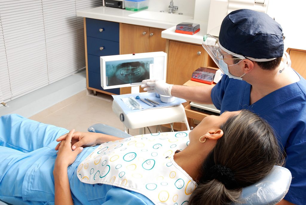 Woman looking at her dental x-ray before her wisdom teeth removal Mulgrave procedure
